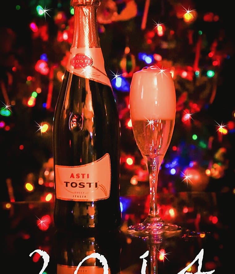 Champagne glasses under string lights
